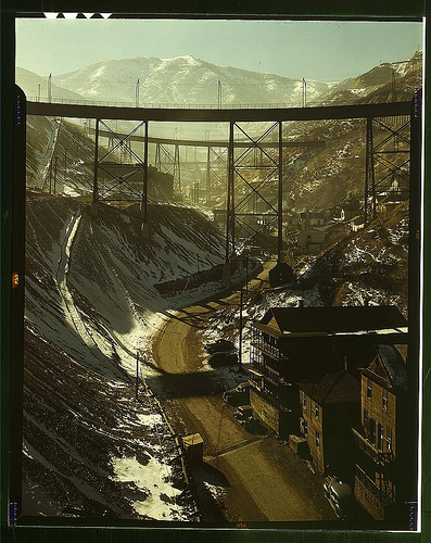 Carr Fork Canyon as seen from "G" bridge, Bingham Copper Mine, Utah. In the background can be seen a train with waste or over-burden material on its way to the dump (LOC)